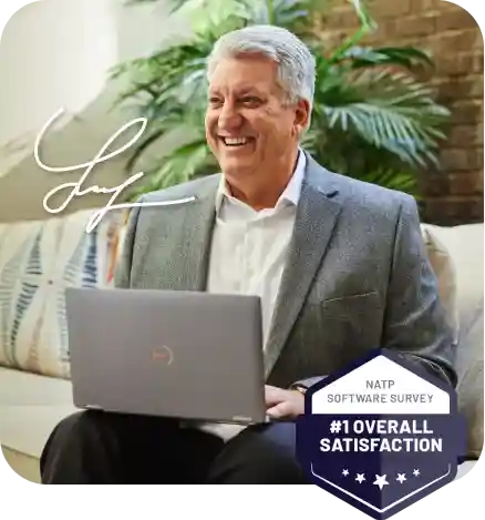 smiling older man sitting at computer