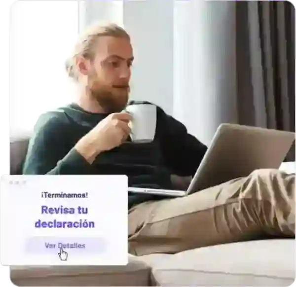 man drinking coffee and working on a laptop